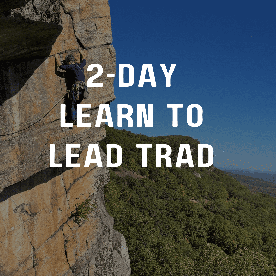 A man climbing up the side of a rock wall.