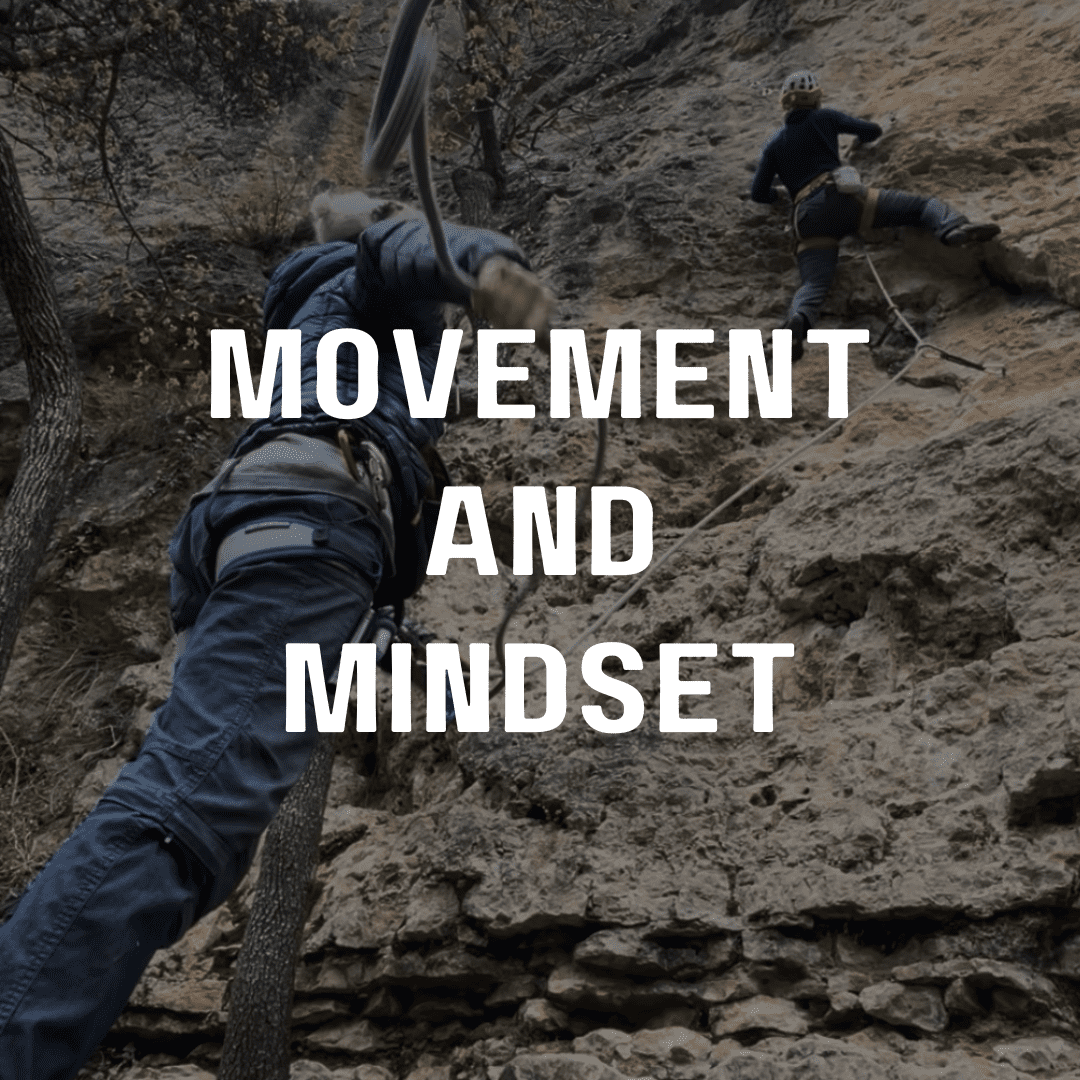 A man climbing up the side of a mountain.